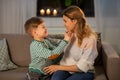 Happy smiling mother talking to her son at home Royalty Free Stock Photo