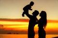 .Family in love with son hugging at sunset, silhouette Royalty Free Stock Photo