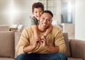 Family, love and trust with a father and son sitting on a sofa in the living room of their home while bonding together Royalty Free Stock Photo
