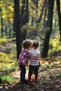 Family love and trust. Little boy kiss small girl friend in autumn forest. Brother kiss sister with love in woods Royalty Free Stock Photo