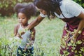 Family lovely gardening watering green plant activity with children during Stay at Home to reduce the outbreak of the Coronavirus