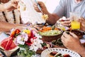 Family at lunch scene with unrecognizable caucasian mixed ages people eating and drinking together having fun for tradition or