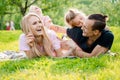 Family lying on grass in countryside Royalty Free Stock Photo