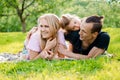 Family lying on grass in countryside Royalty Free Stock Photo