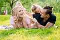 Family lying on grass in countryside Royalty Free Stock Photo