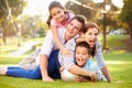 Family Lying On Grass In Park Together