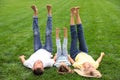 Happy family lying on green grass in park Royalty Free Stock Photo