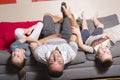 Family lying upside down on sofa Royalty Free Stock Photo