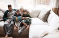 Family makes story time even more fun. two adorable brothers reading a book together with their parents while relaxing Royalty Free Stock Photo