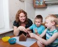 Family making gingerbread house