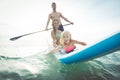 Family making paddle surf in the ocean