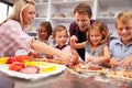 Family making pizza for dinner Royalty Free Stock Photo