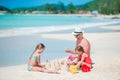 Family making sand castle at tropical white beach Royalty Free Stock Photo