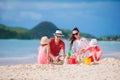 Family making sand castle on white beach on summer holidays Royalty Free Stock Photo