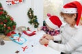 Family making seasonal greeting cards together at christmas time, grandmother with granddaughter at home Royalty Free Stock Photo