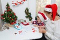 Family making seasonal greeting cards together at christmas time, grandmother with granddaughter at home Royalty Free Stock Photo