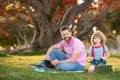 Family man business online. Father and son working on laptop remote in the park. Royalty Free Stock Photo