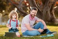 Family man business online. Father and son working on laptop remote in the park. Royalty Free Stock Photo