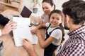 Family man with wife and daughter signs sales contract in office of realtor. Royalty Free Stock Photo