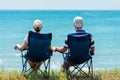 Family man and woman relax and unwind in camping chairs