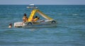 Family on a marine pedal catamaran at Marina San Nicola beach in Italy