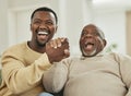 Family means nobody gets left behind or forgotten. a father and son laughing in the lounge.