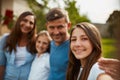 Family means the world to me. Cropped portrait of a young family of four standing outside.