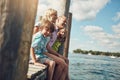 Family means the world to us. a young family on a pier while out by the lake.