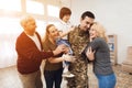 The family meets a man in camouflage at home. Royalty Free Stock Photo