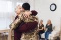 The family meets a man in camouflage at home. Royalty Free Stock Photo