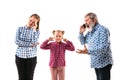 Family members arguing with one another on white studio background. Royalty Free Stock Photo