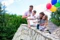 Family members bent on the side of the stone bridge Royalty Free Stock Photo