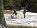 A family makes a snowman in the snow