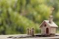 Family members, Mini wooden house on a pile of coins on table. Family tax benefit, residential property tax concept: depicts home Royalty Free Stock Photo