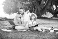 Family man business online. Father and son working on laptop remote in the park. Royalty Free Stock Photo