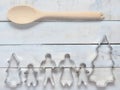 Family metal cookie or biscuit cutter composed of father, mother, brother, sister and pine tree with wooden spoon and fork or ladl