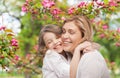 Happy mother and daughter hugging over garden