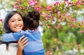 Happy mother and daughter hugging over garden