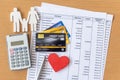 Family model and calculator on Bank statement and credit card on a Wooden table Royalty Free Stock Photo