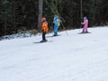 Family of mom dad and daughter roll down the mountain on downhill skiing. Bulgaria, Bansko-January, 2011 Royalty Free Stock Photo