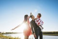 Family, mom, dad holding the daughter happy and beautiful sunset