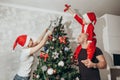 Family - mom, dad and son decorate the Christmas tree from above Royalty Free Stock Photo