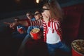 Family mom father and children are watching a projector, TV, cinema, movies with popcorn in the cinema. Royalty Free Stock Photo