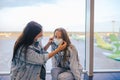 Mother and little girl with medical masks at airport. Protection against Coronavirus and gripp Royalty Free Stock Photo