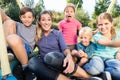 Family with mom, sons and daughters taking photo together