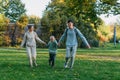a family mom and 2 sons are having fun, running in the park and jumping. Sons, children, mom, run, play, rejoice, enjoy Royalty Free Stock Photo