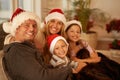 Family moments at Christmas time. Portrait of a happy young family on Christmas day. Royalty Free Stock Photo