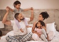 Family morning, bed relax and parents happy with children in bed, smile in bedroom of house and love for kids in home Royalty Free Stock Photo