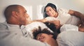 Family, morning and happy in home bedroom bed playing, bonding and gratitude for love. African woman, man and kids lying Royalty Free Stock Photo