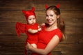 Family mother and baby son celebrate Halloween in devil costume Royalty Free Stock Photo